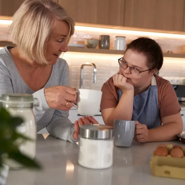 down-syndrome-woman-and-her-mother-chatting down-syndrome-woman-and-her-mother-chatting